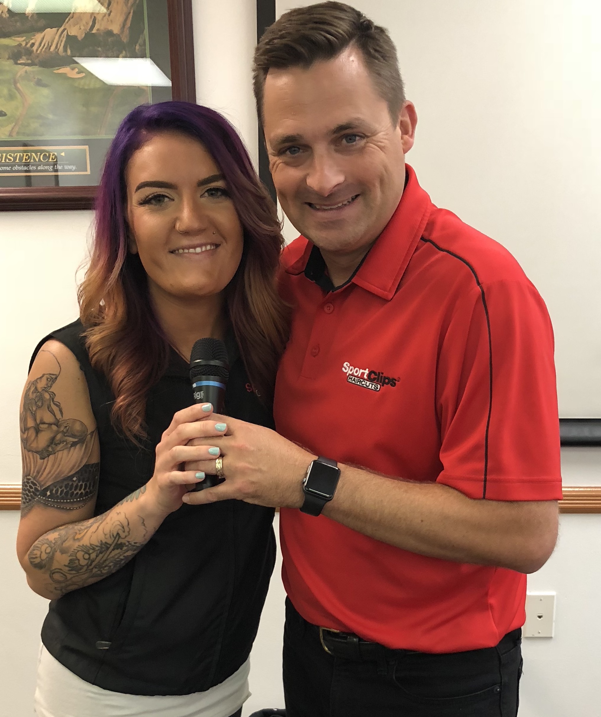 Shayne Hefferon and Chad Jordan holding a microphone